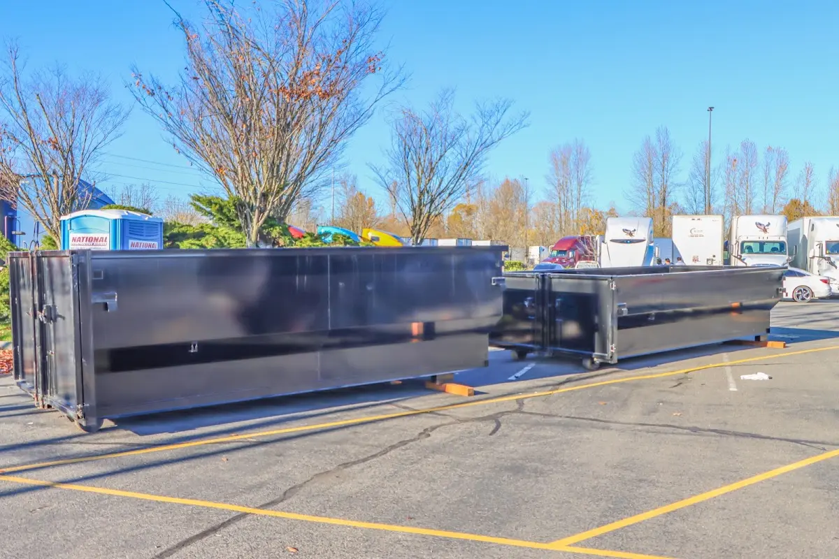 Professional dumpster rental service with roll-off container on residential driveway in Woodland